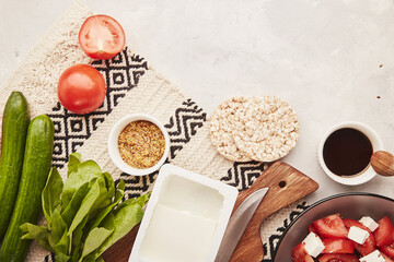  Aesthetic healthy low fodmap food ingredients with copy space - vegetables, fruits, greens, salad with feta. Flat lay.