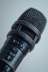 A close-up view of a microphone placed on a table. This image can be used for various purposes