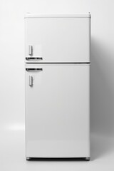 A white refrigerator freezer positioned against a white wall. Can be used for home appliance advertisements or interior design concepts