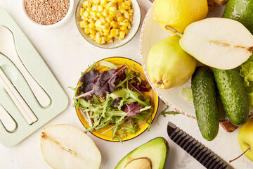 Healthy low fodmap, Mediterranean diet - vegetables, fruits, greens, flax seeds with cutlery. Plant based diet ingredients close up.