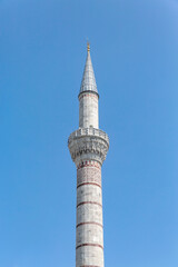 Fototapeta na wymiar Minaret of Bayezid II Mosque (Bayezid Camii). Clear bkue sky at background. Istanbul, Turkiye (Turkey)
