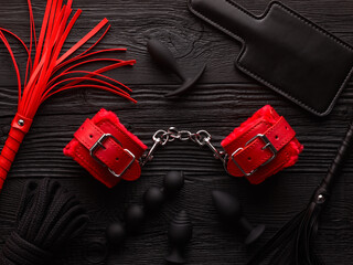 Set of BDSM toys over black wooden background