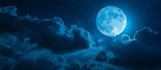 The night sky is illuminated by moonlight as a full moon shines through the clouds, creating an ethereal atmosphere