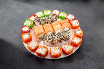Assorted sushi rolls with salmon, tobiko caviar, and sesame seeds, a feast for sushi enthusiasts
