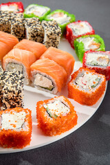 Assorted sushi rolls with salmon, tobiko caviar, and sesame seeds, a feast for sushi enthusiasts
