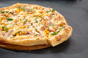 Hawaiian pizza with chicken, pineapple, and corn, a sweet and savory combination on a perfectly baked crust