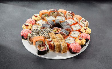 Classic and baked sushi rolls assortment; Philadelphia rolls topped with spicy sauce, a mix of warmth and tradition