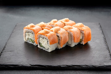 Baked Philadelphia sushi rolls with spicy sauce, offering a creamy and tangy taste in each bite
