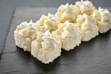 Cheese roll wrapped in cheese and adorned with cream cheese caps; a double cheese sensation in a...