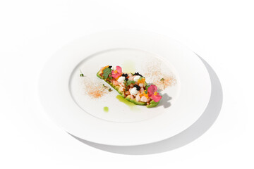 Gourmet avocado with shrimp tartare, mango, cream cheese, and black caviar on a pristine white plate