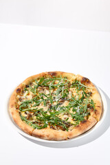 Italian pizza with cheese and mushrooms, topped with fresh arugula
