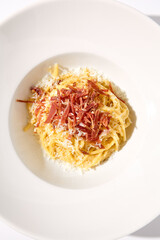 Top View of Classic Italian Carbonara Pasta with Bacon, Cheese, and Egg Yolks, Perfect for High-End Culinary Magazines