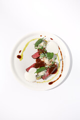 Pan-seared veal cutlet with cheese espuma and Demi-glace sauce, artfully arranged on a white plate, top view - ideal for modern gastronomy concepts