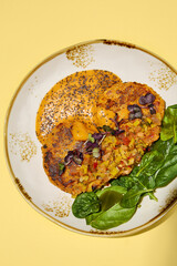 Vegan Sweet Potato Cakes with Vegetable Salsa and Spinach, Top View. Ideal for Clean Eating and Health-Focused Food Marketing