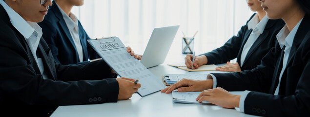 Two business executive in boardroom discuss term and company merging agreement, review corporate...