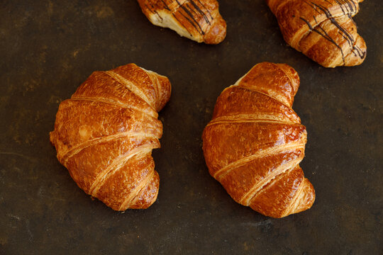 Croissant with butter two pieces on a black board
