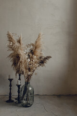 trocen flovers in the glass near the wall in loft