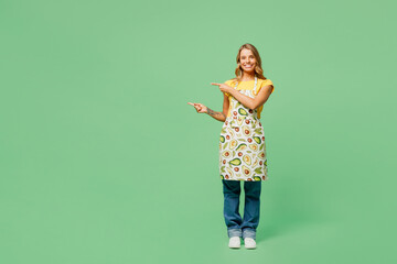 Full body happy young housewife housekeeper chef cook baker woman wear apron yellow t-shirt look...