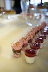 Festive table with pastries, mousses and fruits.