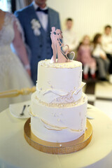 The bride and groom cut the festive wedding cake. Wedding traditions.