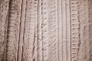 Tire tread prints on the ground. tire tracks. Tire tracks on a sandy road. Car tread prints on the...