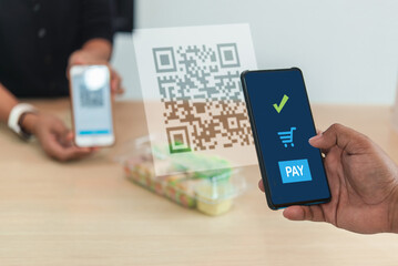 Person using a mobile phone to scan a QR code for secure cashless payment or information retrieval..