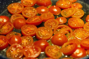 A cherry tomatoes baked in olive oil in a pan, healthy dietary food, diet.