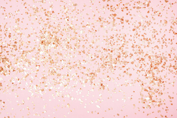 Golden sparkles on pink pastel trendy background. Festive backdrop for your projects.