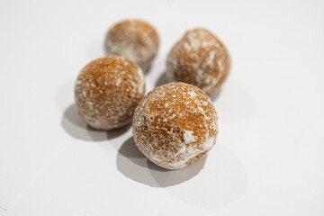 fresh donuts, bread, close-up view, on a light background, blurred background, bakery, baking, donut, sweets, sprinkled with powdered sugar
