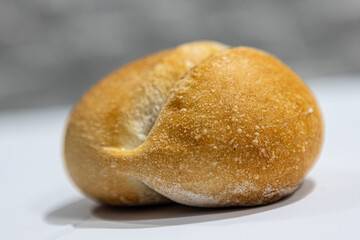 fresh roll, bread, close-up view, on a light background, blurred background, bakery, baking bread, rolls
