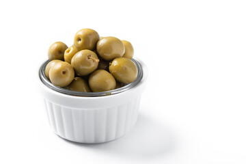 Green olives in white bowl isolated on white background. Copy space