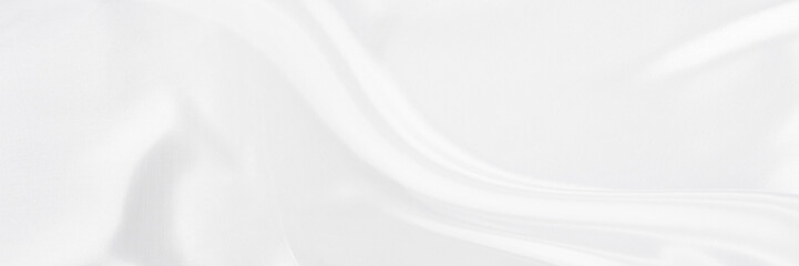 White gray satin texture that is white silver fabric silk panorama background with beautiful soft blur pattern natural.