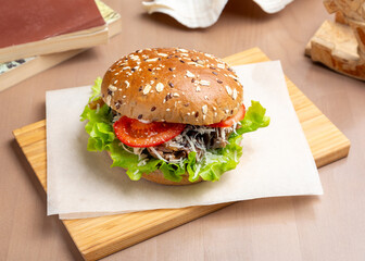 Sandwich, burger with roast beef, cheese and tomatoes. Breakfast