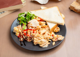 Scramble with chicken and tomato. Breakfast