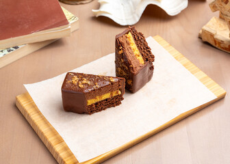 Dessert chocolate bar with mango on a wooden board.