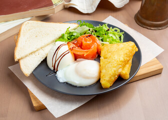 Poached eggs, salmon, hash browns, toast. Breakfast.