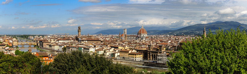 Fototapeta na wymiar View over the Arno river, the Palazzo Vecchio and the Florence Cathedral in Florence, Tuscany, Italy, on a sunny day in spring.