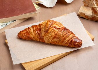 French classic croissant on a wooden board. Breakfast.