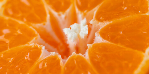 Close-up photo of a tangerine slice. Fruit background.