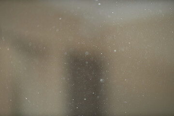 Dust, small particles fly through the air in the sunshine.