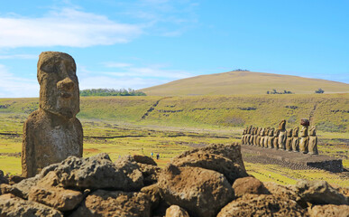 Fototapeta premium Moai A Vere Ki Haho or Traveling Moai with the Iconic 15 Moai statues of Ahu Tongariki ceremonial platform in background, Easter island, Chile, South America