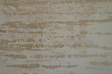 Close shot of beige semi-smooth wall with stucco lace finish - obrazy, fototapety, plakaty