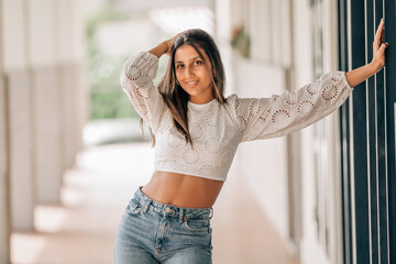 smiling beautiful woman posing on the wall