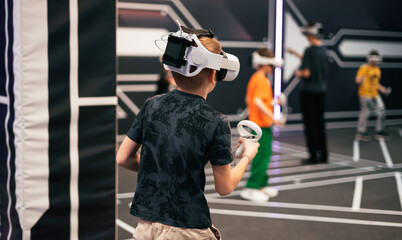 A young boy wearing a virtual reality headset with the number 14 on it
