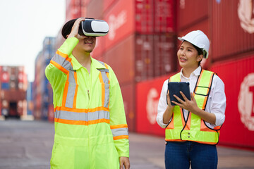 worker or engineer wearing virtual reality glasses(VR) in containers warehouse storage