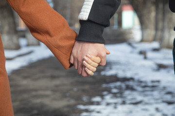 Young couple holding hands at outdoors.