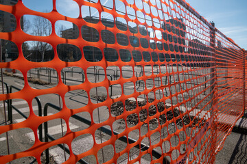 work in progress on a construction site, high visibility net and fence of a construction site with...