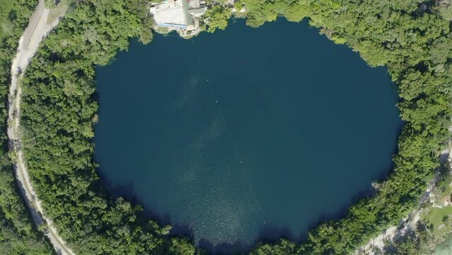 Aerial view of the Cenote in the Bacalar Lake, boats are sailig around it
