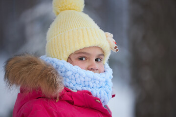 Young Girl With Yellow and Blue Hat and Scarf