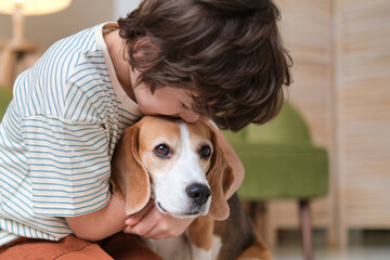 tender hug from a child to his beagle, an image that captures the affectionate bond and trust...